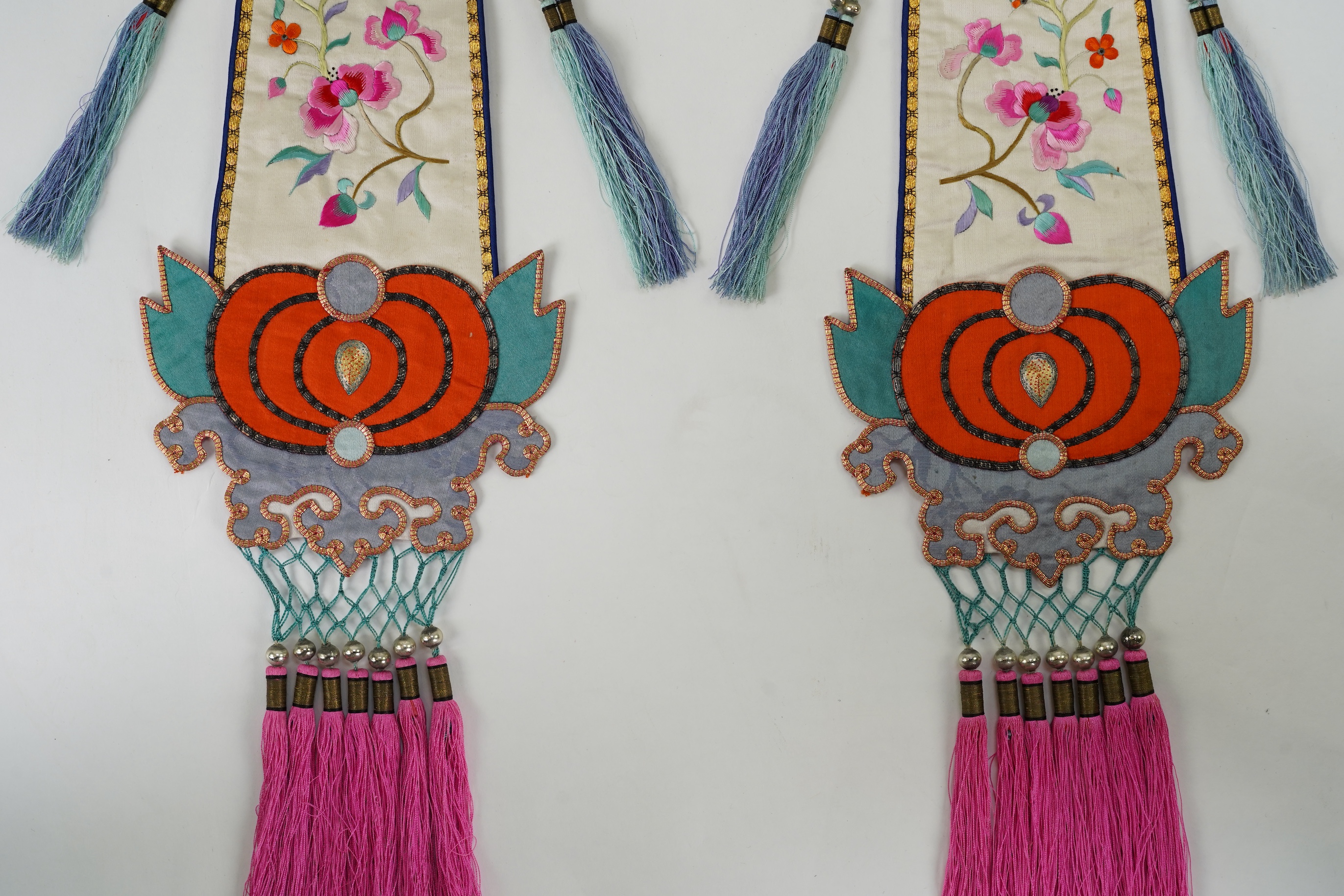 A pair of Chinese embroidered silk hanging pendants, early 20th century